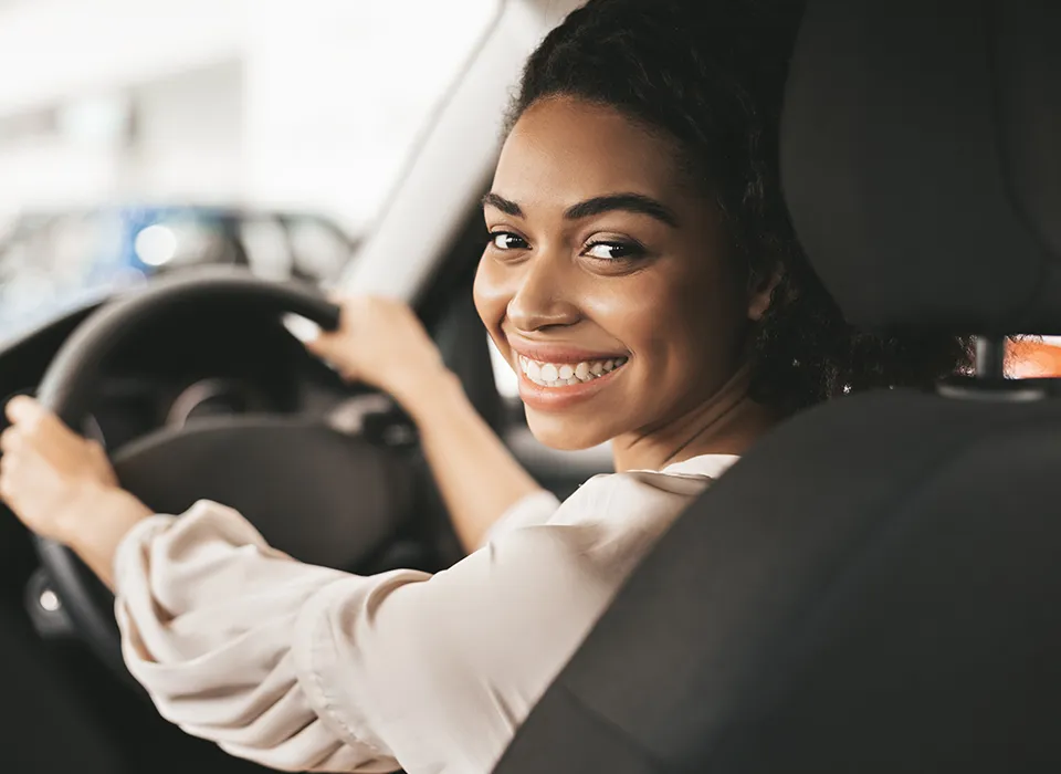 Person smiling while driving their JMC vehicle